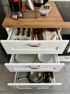 an open kitchen counter with white drawers and dishes at Casa Lamar in Salerno