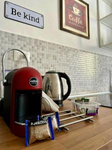 a red toaster sitting on top of a kitchen counter at Casa Lamar in Salerno