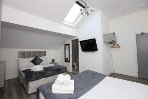 a hotel room with two beds and a television at Hotel Anfield in Liverpool