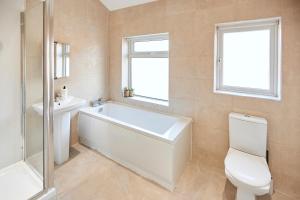 a bathroom with a tub and a toilet and a sink at Host & Stay - Fairfield in Manchester