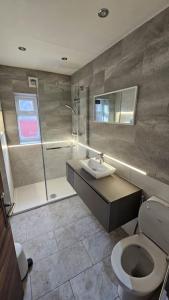 a bathroom with a toilet and a sink and a shower at Manchester, Rusholme, UK with free parking in Manchester