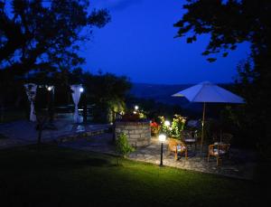 patio ze stołem i parasolem w nocy w obiekcie HURZ - giardino sannita w mieście Pietrelcina