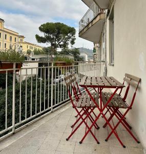 a table and two chairs sitting on a balcony at Casa Lamar in Salerno