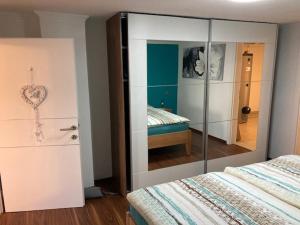 a bedroom with a mirrored closet and a bed at Haus am Fuße des Semmerings in Schottwien