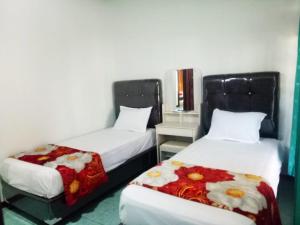 Ένα ή περισσότερα κρεβάτια σε δωμάτιο στο HOMESTAY KARTINI SYARIAH