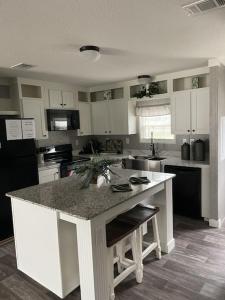 a kitchen with a island in the middle of it at Sweet retreat in the springs NOT waterfront property in Homosassa