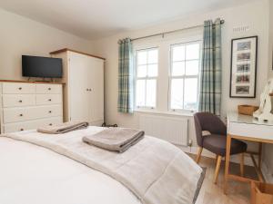 a bedroom with a bed and a desk and a desk at Timley Knott in Coniston