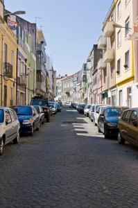 a street with cars parked on the side of the road at Romantic & Renewed 1 bedroom Apartment in Campolide - 67 1E in Lisbon