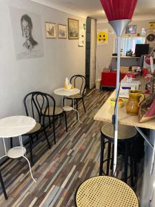 a restaurant with tables and chairs in a room at Guest House Roma in Genoa