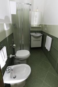 a bathroom with a white toilet and a sink at Dolce Salento in Villaggio Resta