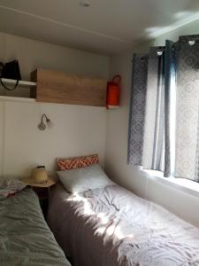 Cama o camas de una habitación en Bungalow de 3 chambres avec piscine partagee terrasse amenagee et wifi a Saint Cyprien a 3 km de la plage