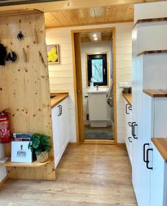 a tiny house with a kitchen and a bathroom at Tiny house with garden and jacuzzi near Amsterdam in Vijfhuizen