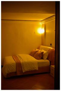 a bedroom with two beds with a light on the wall at Ruby Haven in Kampala