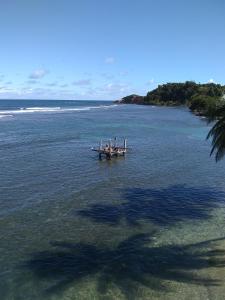 a group of people on a boat in the water at Calibishie Sandbar in Calibishie