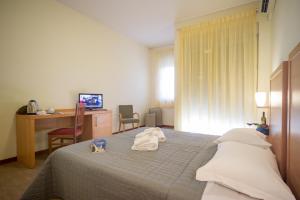 a hotel room with a bed with towels on it at Hotel Foresteria in Volterra