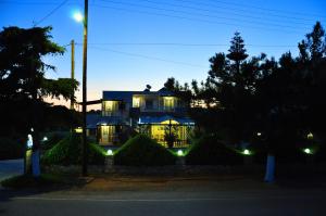 a house lit up at night with lights at Lagos Studios & Apartments in Palekastron