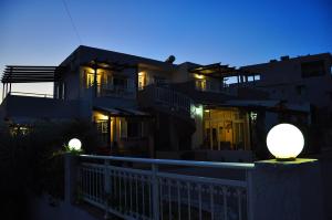a house with two lights in front of it at night at Lagos Studios & Apartments in Palekastron