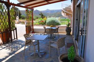 a table and chairs on a patio with a view at Lagos Studios & Apartments in Palekastron