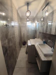 a bathroom with a sink and a shower at OFİSADA in Sakarya