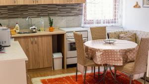a kitchen with a table and chairs in a kitchen at apartment HOME in Bihać