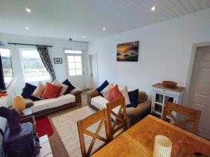a living room with a couch and a table at Cosy Cottage by the Sea in Galway
