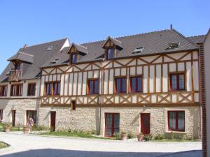 um grande edifício com um telhado de gambrel em Les Belleme Golf - Self-catering Apartments em Bellême