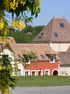 a red and white house with a roof at Les Belleme Golf - Self-catering Apartments in Bellême