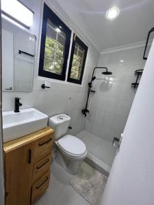 a bathroom with a toilet and a sink at Luxe cozy home in Dar es Salaam