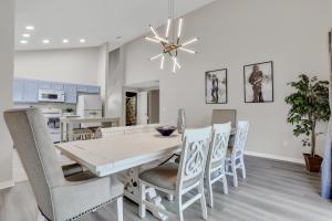 a white dining room with a table and chairs at Palm Daydreams in Davenport