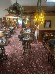 a restaurant with tables and chairs and a chandelier at The Flask Inn in Robin Hood's Bay