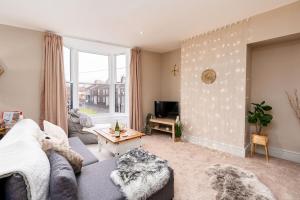a living room with a couch and a table at The Cosy Norse Retreat in York