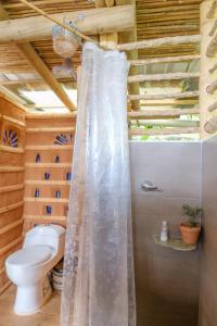 a shower curtain in a bathroom with a toilet at Tabatinga, Hermosa Cabaña Privada en Reserva Natural - Cali Valle del Cauca in Cali