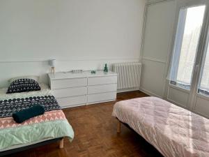 Ένα ή περισσότερα κρεβάτια σε δωμάτιο στο Le temps du Loing