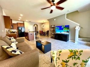 a living room with a couch and a flat screen tv at A Cozy Home Away From Home in Riverview