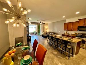 a kitchen and living room with a table and chairs at A Cozy Home Away From Home in Riverview