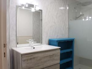 a bathroom with a sink and a mirror at Maison Port-la-Nouvelle, 3 pièces, 7 personnes - FR-1-229C-673 in Port-la-Nouvelle