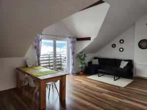 a living room with a table and a couch at Apartament u Ewki in Rdzawka