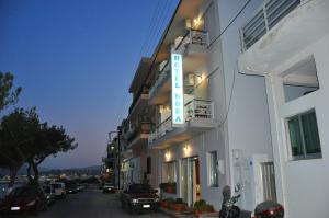 a hotel sign on the side of a building at Nora Hotel in Sitia