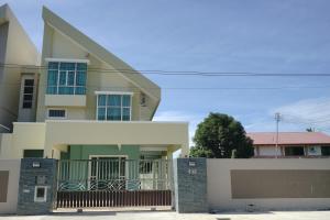 a house with a fence in front of it at Likas House @ Alawa Homes in Kota Kinabalu