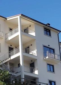 a white apartment building with balconies on it at Casa da Forja in Aldeia das Dez