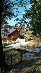 una valla frente a una granja con un edificio en Domek nad Kryniczanką en Krynica Zdrój