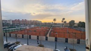 a view of a tennis court in a parking lot at Rooms on Malvarrosa beach in Valencia