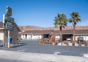 a street in a town with palm trees and a motel at Route 66 Motel in Barstow