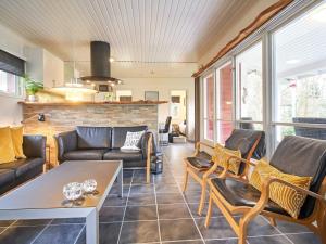 a living room with a couch and chairs and a table at 4 person holiday home in Aakirkeby in Vester Sømarken