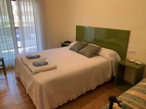 een slaapkamer met een groot bed en handdoeken bij Logroño: Piso con Garaje y Piscina. in Logroño