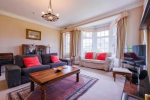 a living room with a couch and a table at Newholme House in Stirling