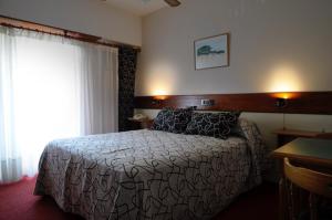 Una cama o camas en una habitación de Hosteria San Marcos