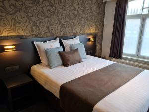 Ein Bett oder Betten in einem Zimmer der Unterkunft Hotel Kristoffel