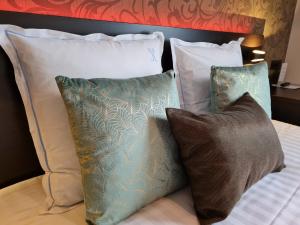 a group of pillows sitting on a bed at Hotel Kristoffel in Middelkerke