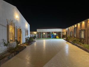 a courtyard of a building with a playground at night at شاليهات ليالي زين الشرف 1 in Taif